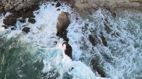 Overhead view of the waves crashing on rocks in the ocean Stock Footage 201102726