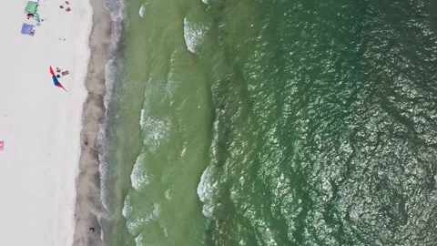 Overhead View of Waves Gently Rolling Onto a Quiet White Sand Beach Vídeo Stock 336704849