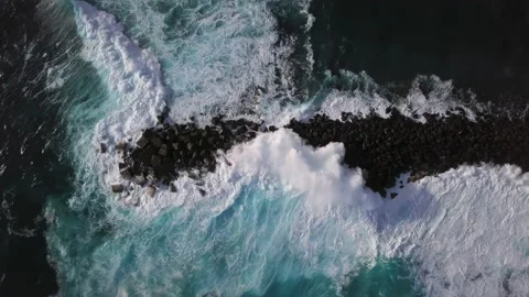 Overhead view of waves splash on rocks Stock Footage 169866930