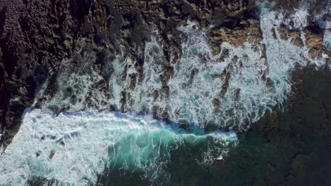 Overhead view of waves splash on rocks Stock Footage 197164273