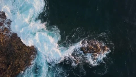 Overhead view of waves splash on rocks Stock Footage 241492509