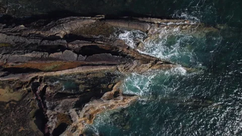 Overhead view of waves splash on rocks Stock Footage 273378786