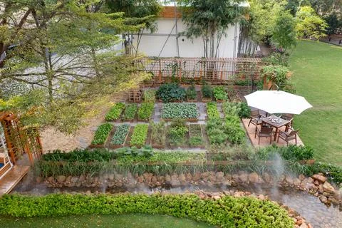 An overhead view of a well-organized backyard vegetable garden with raised .. Stock Photos