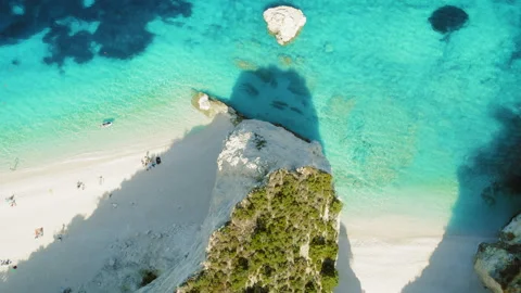 Overhead view of white sand beach and turquoise sea with people sunbathing in Video stock 319872269