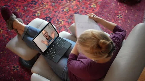 Overhead view of woman with notebook talking to co-worker on tablet computer Stock-Footage 147230588