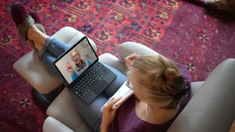 Overhead view of woman with notebook talking to co-worker on tablet computer Stock-Footage 147230659