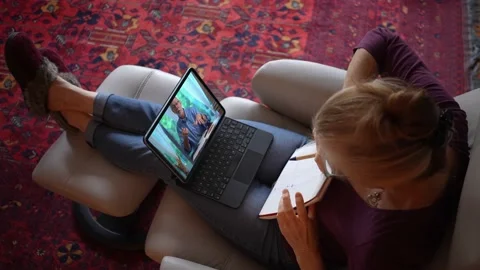 Overhead view of woman with notebook talking to co-worker on tablet computer Stock-Footage 147230809
