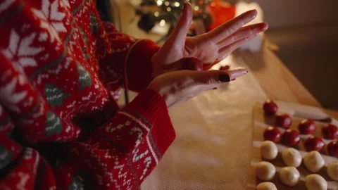 Overhead View of Woman Rolling Red Dough Ball on Palm Over Baking Sheet with Stock Footage 316818460
