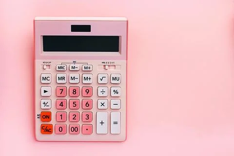 Overhead view working table. on a pink background a pink calculator 写真素材