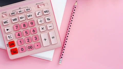Overhead view working table. on a pink background, a pink calculator, a blank Photos