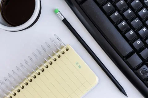 Overhead view of a workplace on white background Stock Photos