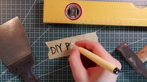 Overhead view of writing DIY PROJECT on tape mockup with tools. Stock Footage 337816252