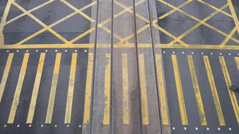 Overhead View of Yellow-Painted Zebra Crossing at Busy Intersection in Hong Kong Stock Footage 294661602