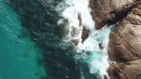 Overhead of Waves Crashing on Rocks Stock Footage 164178372