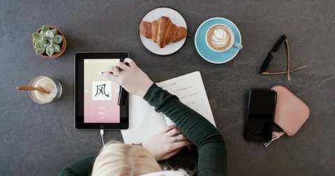 Overhead of woman in cafe using foreign language learn chinese mobile phone app Stock Footage 90316395