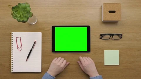 Overhead Of Woman Using Digital Tablet At Wooden Desk Stock Footage 79650342