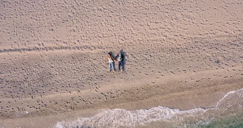 Overhead of Young Couple on the beach Stock Footage 128301000