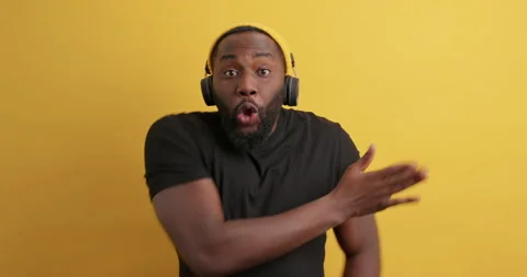 Overjoyed amused bearded man with dark skin has fun dances and moves actively Stock Footage 150296048