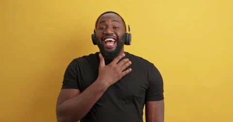 Overjoyed bearded dark skinned guy laughs out hears funny story keeps hand on Stock Footage 150297939