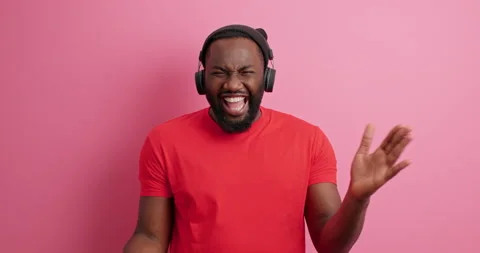 Overjoyed dark skinned guy points directly at camera laughs happily listens Stock Footage 151194200