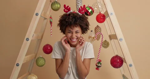 Overjoyed dark skinned young Afro American woman keeps hands on cheeks awaits Stock Footage 144048298