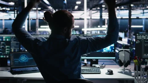 Overjoyed data center engineer dancing on chair after implementing AI Stock Footage 313567510
