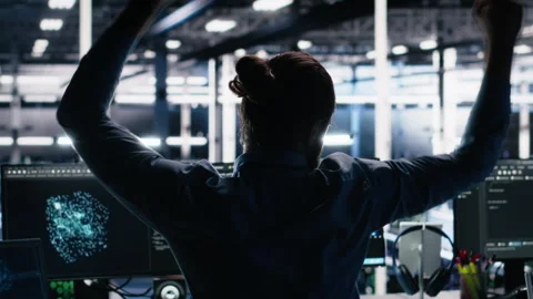 Overjoyed data center engineer dancing on chair after implementing AI Stock Footage 313635316