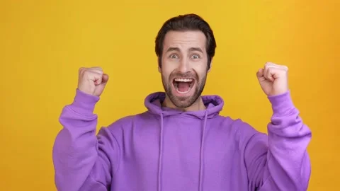 Overjoyed guy luck fortune hands up shout isolated bright color background Stock Footage 165861709