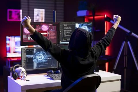 Overjoyed hacker in apartment doing energic celebration after stealing data Stock Photos