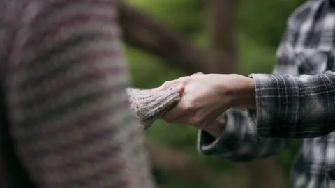 Overjoyed Japanese man presenting a ring to his girlfriend, places it on her fin Stock Footage 199458387