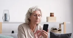 Happy female hold phone chat in social network read good news, shopping via  online store app at home Stock Photo by StudioVK