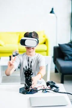 Overjoyed smart boy using his VR glasses Stock Photos