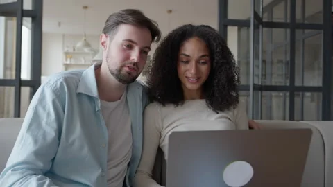 Overjoyed Spouses Waving Hands Talking Laptop, Relaxed Couple Sitting Couch Stock Footage 301244579