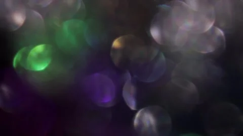 Overlapping bokeh moving to the left in the dark 스톡 동영상 317460060