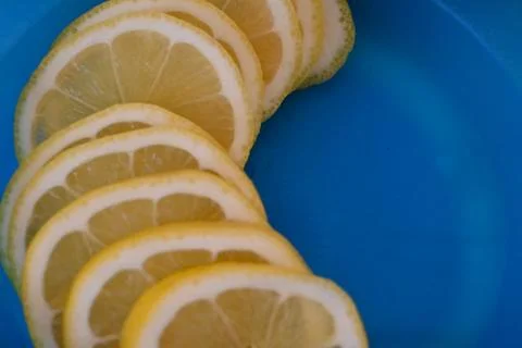 Overlapping lemon slices on a blue background Stock-Fotos