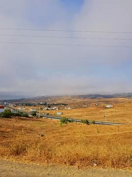 The overlapping meadows extend in warm light toward the horizon Stock Photos