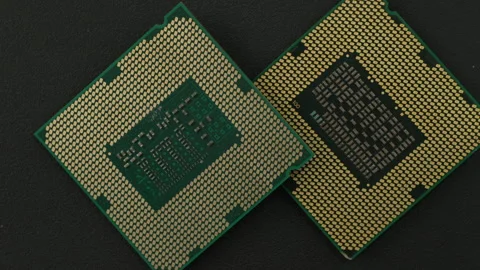 Overlapping Microprocessors Displaying Gold Contact Pins on Dark Background Stock Footage 337016430