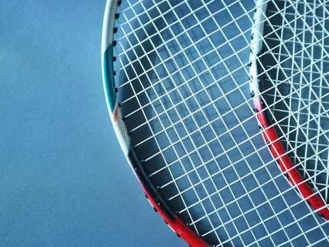 Overlapping rackets on a dark blue background with copy space Stock Photos