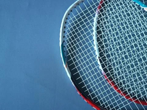 Overlapping rackets on a dark blue background with copy space Stock Photos