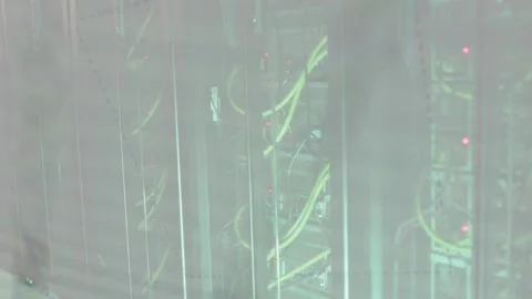 Overlay appearing camera panning across rack showing yellow cables and blinking Stock Footage 333078087