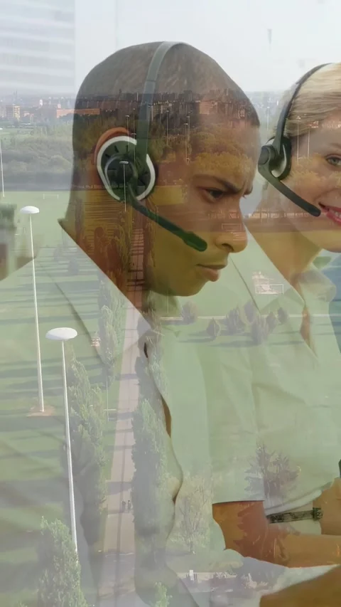 Overlay appearing two call agents monitoring calls, right agent smiling and Stock Footage 331338133