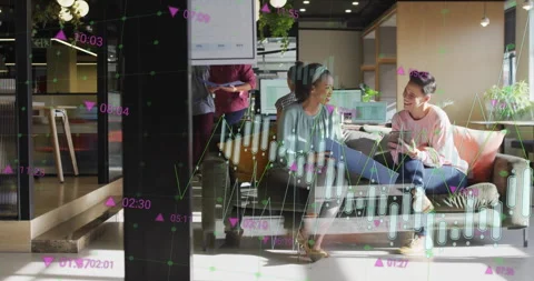Overlay appearing as two women comparing data through laptop and smartphone in Stock Footage 312228855