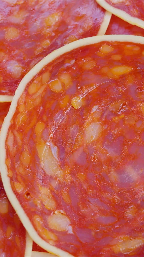 Overlay of red marbled meat, Detailed view of vibrant red marbled chorizo slices Stock Footage 325695751