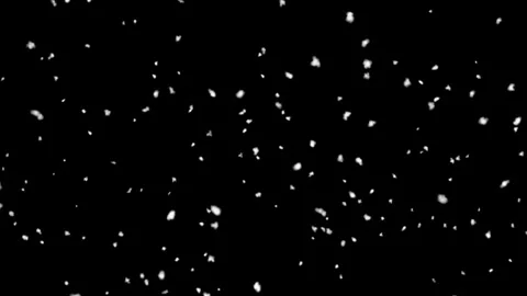 Overlay snowflakes gently falling against dark black background, creating Видео 295469103