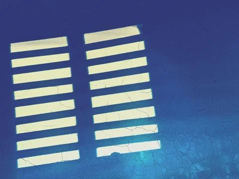 Overlay window light falling on weathered blue wall through window, shadow ba Stock Photos