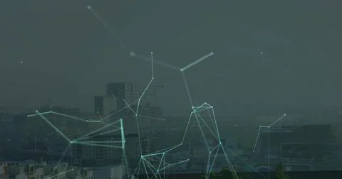 Overlaying digital network glowing nodes connecting across high-rise building 写真素材
