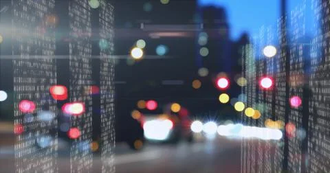Overlaying vertical white binary streams illuminating city street at night, 스톡 사진