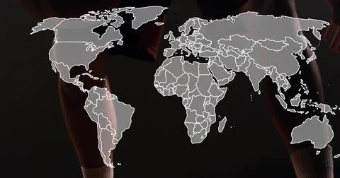 Overlaying white world map over dark studio, man wearing dark athletic shorts Foto stock