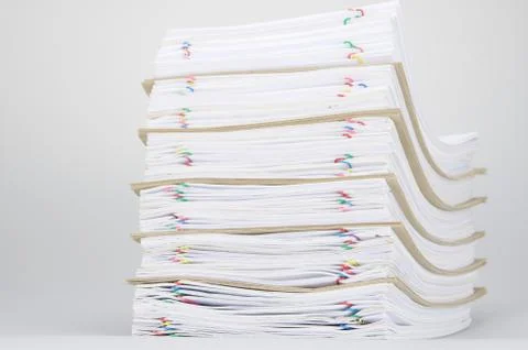 Overload of paperwork and brown envelope with colorful paperclip Stock Photos