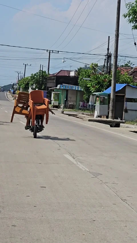 Overloaded Motorcycle Carrying Stack Of Plastic Chairs 스톡 동영상 345328673